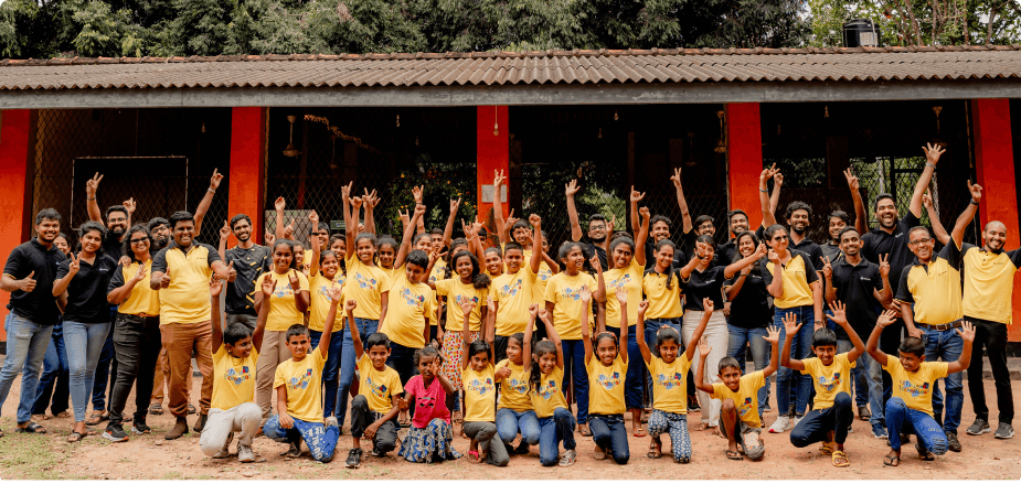 Rootcoders and Students cheering in front of the school building